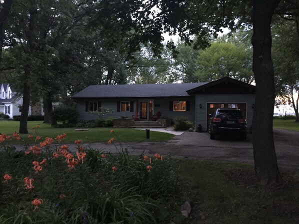 A two-story house with a front porch, a garage, and a driveway. - Retreat on Lake Winnebago (Oshkosh)