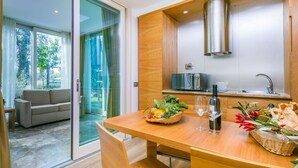 A modern kitchen with a built-in microwave, a stainless steel range hood, and a wooden countertop.