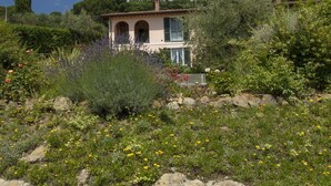 A two-story house with a garden in front.