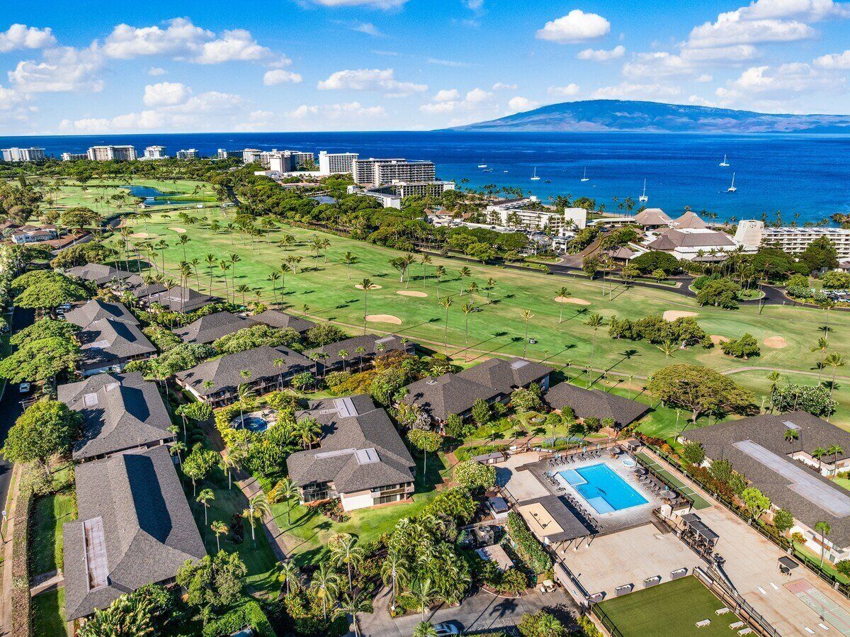 A residential area with houses, a golf course, and a swimming pool.