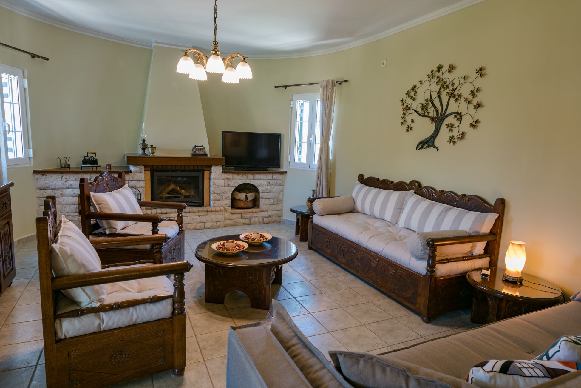 A living room with a fireplace, a sofa, a coffee table, and a television.
