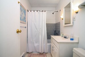 Combined shower/bathtub, hair dryer, towels, toilet paper