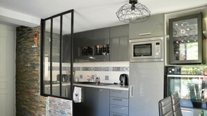 A modern kitchen with grey cabinets, a built-in microwave, and a coffee machine. - House for 4, close to the beach, shared pool (Saint-Hilaire-de-Riez)