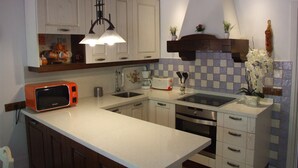 A kitchen with white cabinets, a built-in oven, a microwave, and a sink. - With garden very close to the beach IN COSTABELLA BETWEEN KAPAS AND MONTEROS (WIFI) (Marbella)