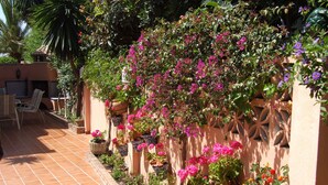 A patio with terracotta tiles, potted plants, and outdoor furniture. - With garden very close to the beach IN COSTABELLA BETWEEN KAPAS AND MONTEROS (WIFI) (Marbella)