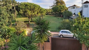 A residential area with a white house, a car parked on a driveway, and a lush green lawn. - With garden very close to the beach IN COSTABELLA BETWEEN KAPAS AND MONTEROS (WIFI) (Marbella)