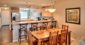 Enjoy meals and social gatherings in this well-equipped kitchen and dining area with a central bar island.