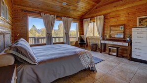 A wooden cabin bedroom with a bed, desk, and dresser. - Huge Mountain Ski & Hike - Wildernest Haven (Silverthorne)