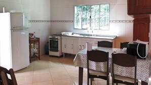 A kitchen with a refrigerator, stove, oven, and window. - HOUSE, FARM, SITE, VERY GREEN 60 KM FROM SPAULO  (Santa Isabel)