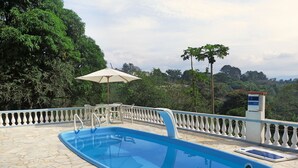 A swimming pool with a stone deck, surrounded by a white balustrade, and overlooking a lush green landscape. - HOUSE, FARM, SITE, VERY GREEN 60 KM FROM SPAULO  (Santa Isabel)