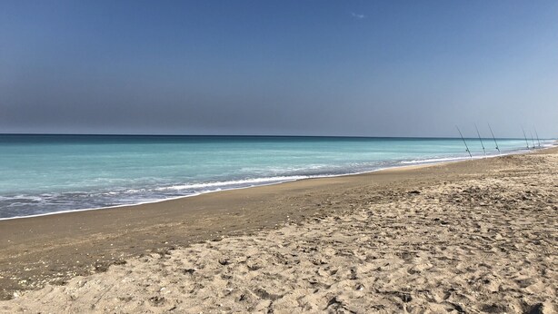 A beach with a clear sky and calm sea. - Ocean Village Beach Condo, Golfcourse and Tennis Resort (Fort Pierce)