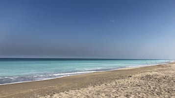 On the beach, sun loungers, beach towels