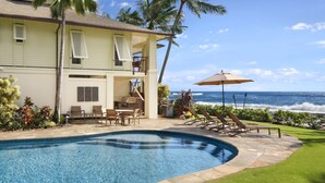 A two-story house with a swimming pool, outdoor seating, and a view of the ocean. - Hale A Kai By Parrish Kauai: spectacular oceanfront views with private pool & AC (Koloa)