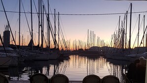 A marina with multiple boats docked, calm water, and a sunset in the background. - La Bastide des Oliviers.charming villa in a peaceful setting with swimming pool
 (callas)