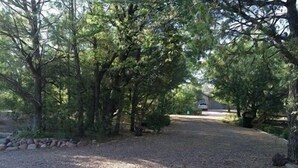A gravel path leading to a building surrounded by trees. - Rim Country Living in the heart of Arizona (Payson)