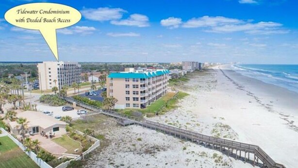 A beachfront condominium complex with a pier leading to the beach. - Beautiful Ponce Inlet 2bd Condo.  100 Yards to the Beach! Beach supplies/bikes.  (Ponce Inlet)