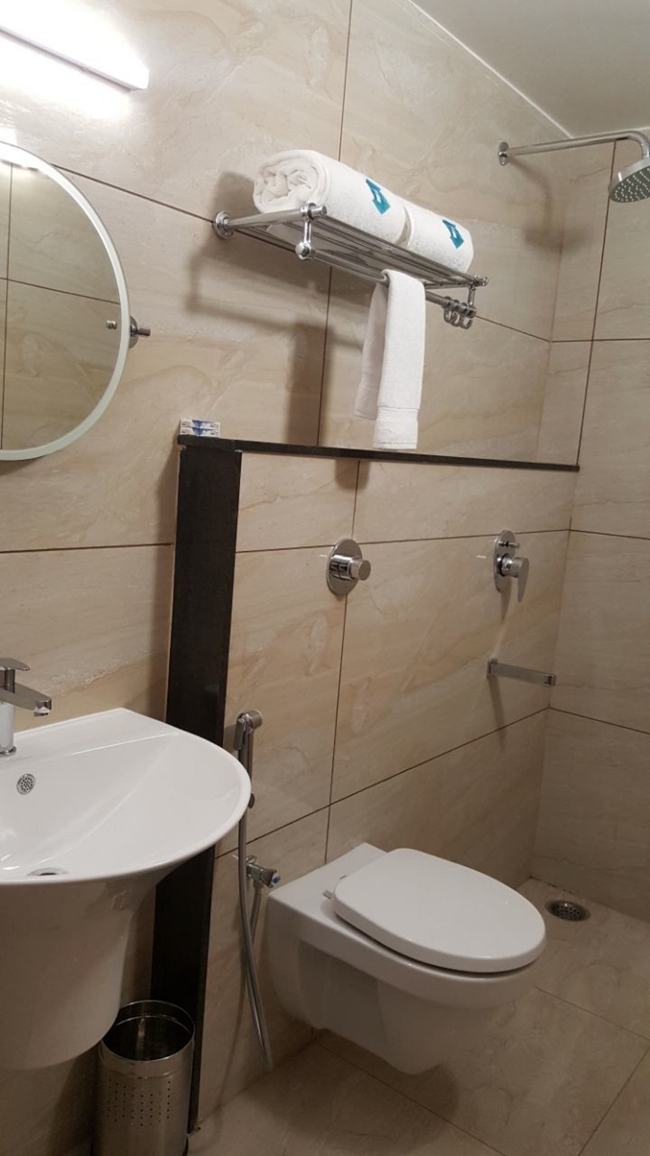 A bathroom with a sink, toilet, and shower.