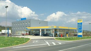 A hotel with a gas station attached, featuring a modern design and multiple fuel pumps. - Hotel Zovko (Sibinj)