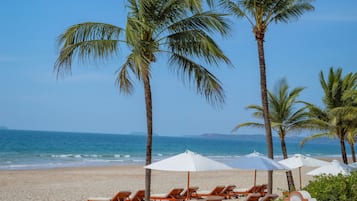 On the beach, sun-loungers, beach umbrellas, beach towels