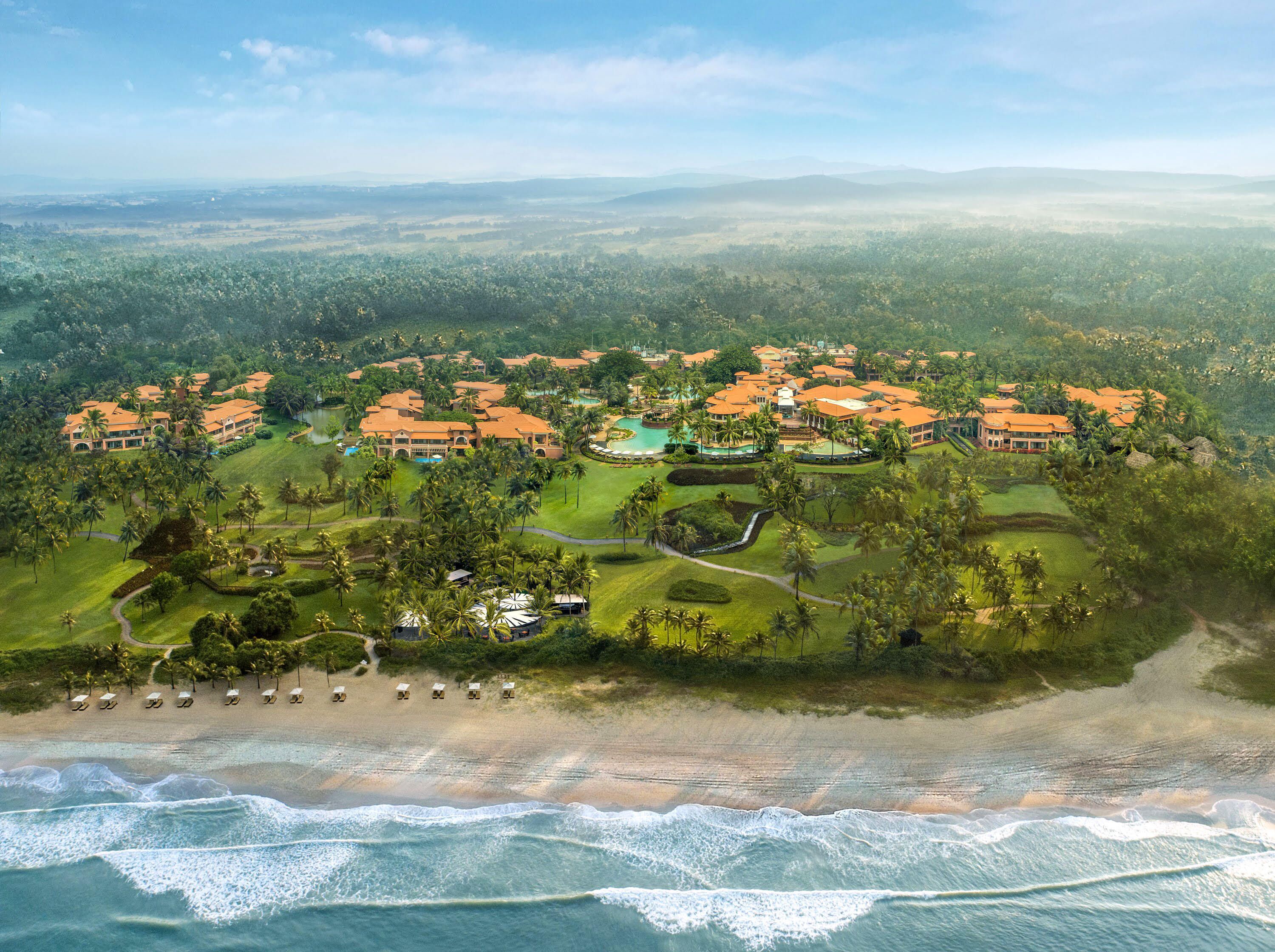 A resort with multiple buildings, a beach, and a golf course.