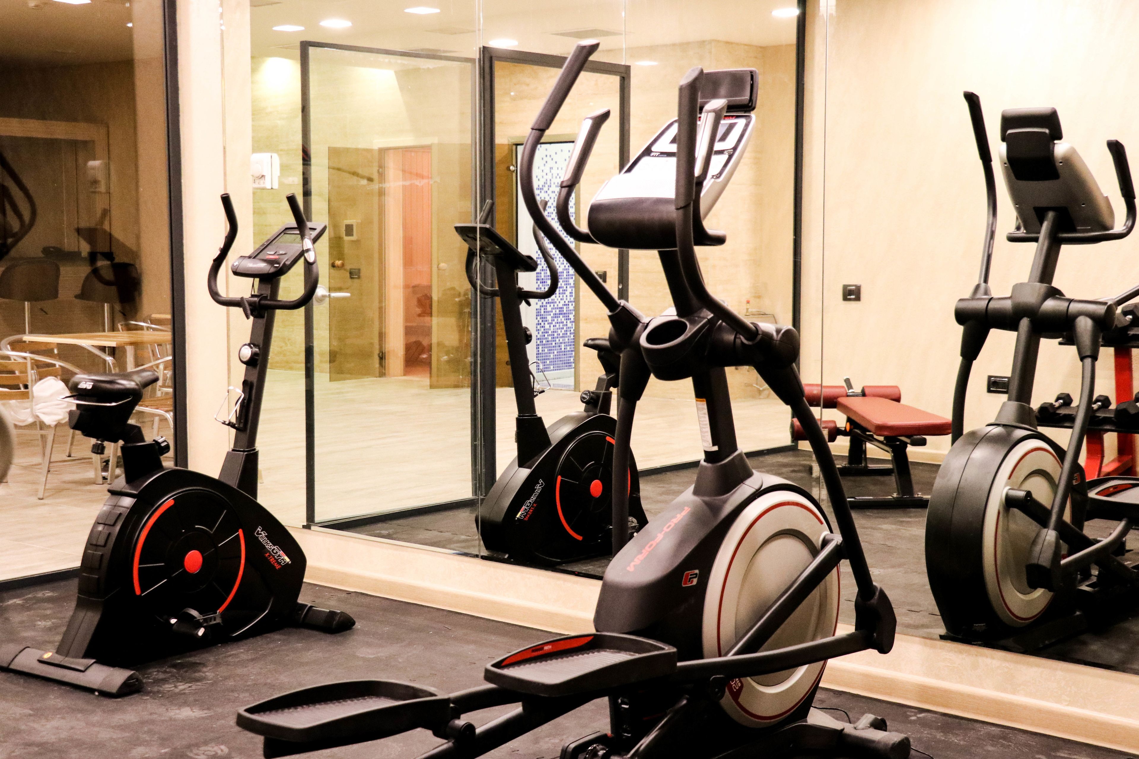 A gym with stationary bikes and a treadmill.
