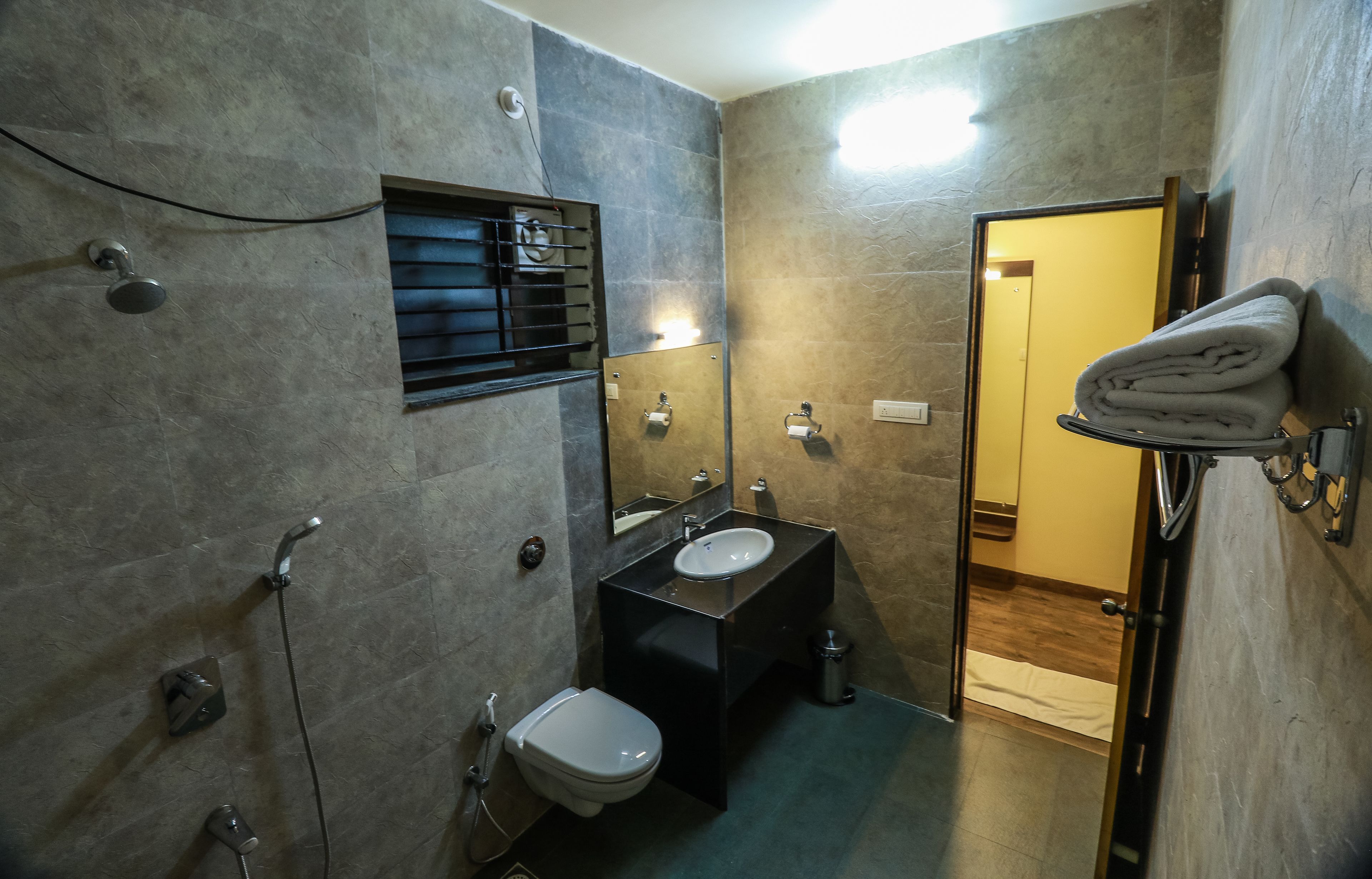 A modern bathroom with a toilet, sink, and shower.
