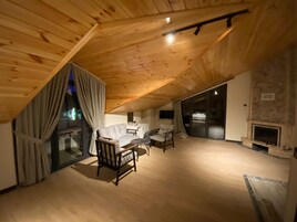 Comfort Room, 1 Double Bed, Non Smoking, Pool View | Living area | LCD TV, fireplace, heated floors