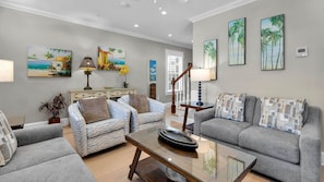 A living room with two sofas, a coffee table, and artwork on the walls. - **THE TOASTED COCONUT @ OLD TOWN** Pool + Last Key White Glove Service... (Key West)