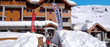 A ski resort building with multiple balconies and a reception area.