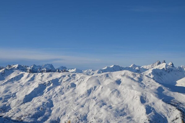 A snow-covered mountain range under a clear sky.