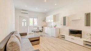 Leilighet, 1 soverom | Oppholdsområde | En 85-centimeters Flatskjerm-TV med Parabol-TV samt TV