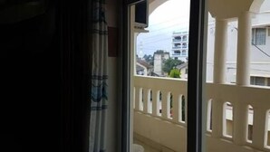 A balcony with a view of buildings and a white bucket on the floor. - Solomon Castle Hotel Mombasa (Mombasa)