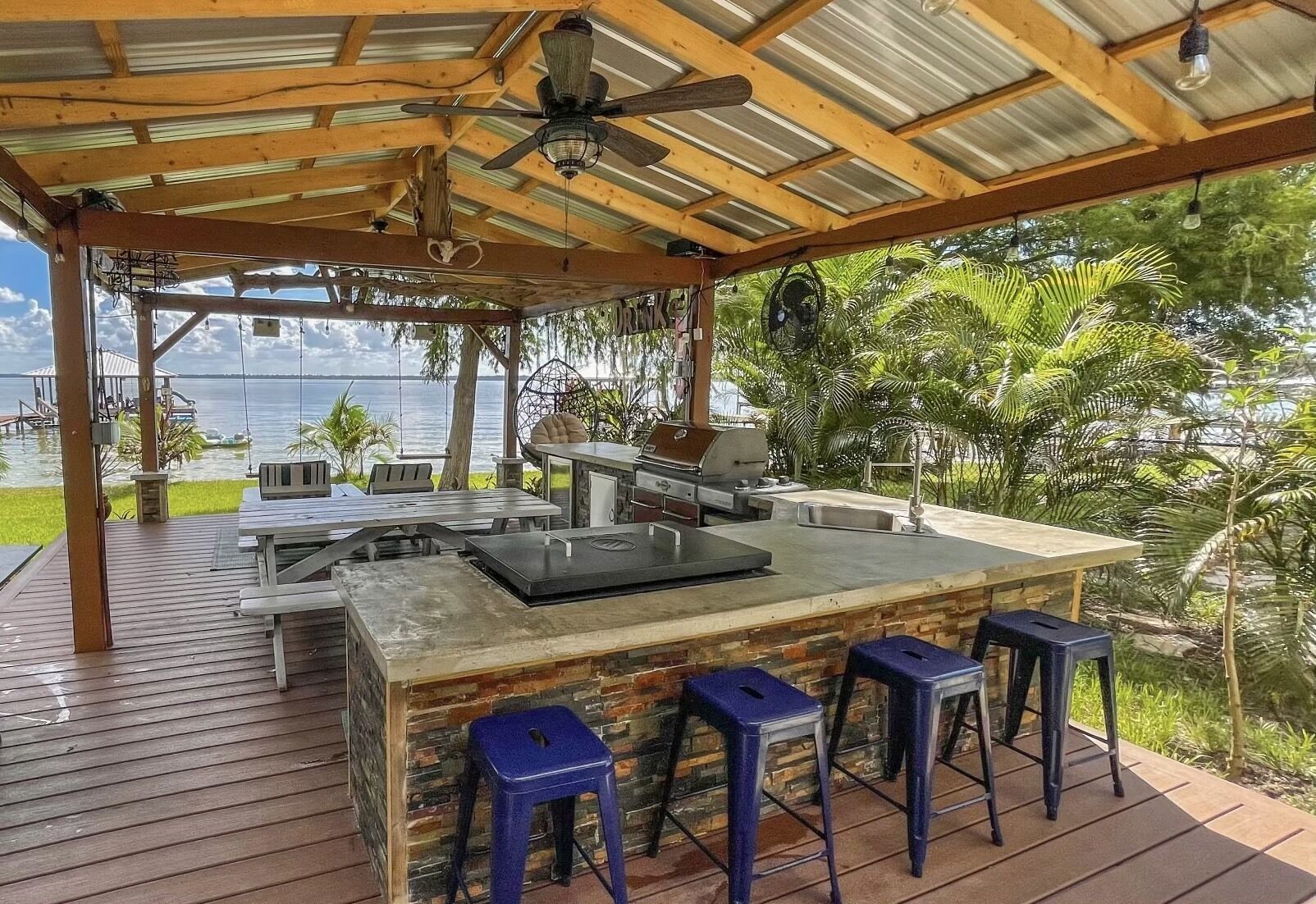 Outdoor kitchen and lakefront pergola