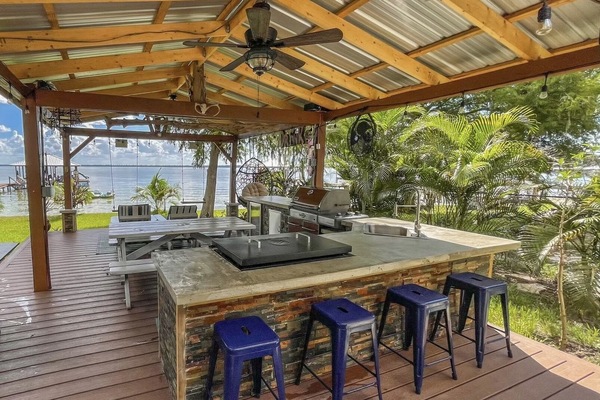 Outdoor kitchen and lakefront pergola