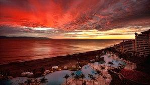 A resort with a pool, beach, and ocean view.