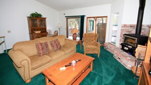 A living room with a sofa, armchair, coffee table, and fireplace. - Forest Creek #3, Pet accepted (Mammoth Lakes)