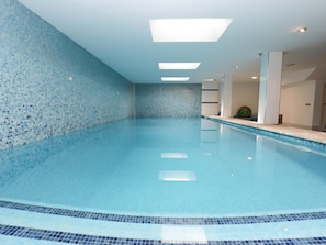 A clear indoor swimming pool with a tiled wall and ceiling lights. - Bohemi, luxury seafront villa (Santa Margalida - Can Picafort/Son Serra Marina)