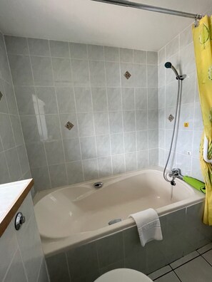 Bathtub, hair dryer, towels, soap