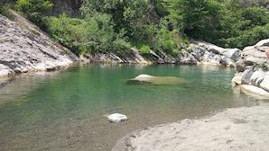 A clear, shallow water body surrounded by rocky terrain and dense greenery. - XVII SEC.  WINE CELLAR, FULLY RENOVATED, WITH SHARED TERRACE AND POOL (Badalucco)