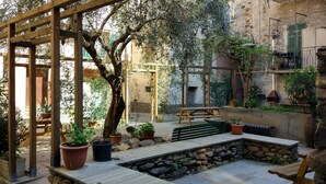 A courtyard with a wooden pergola, stone walls, and potted plants. - XVII SEC.  WINE CELLAR, FULLY RENOVATED, WITH SHARED TERRACE AND POOL (Badalucco)