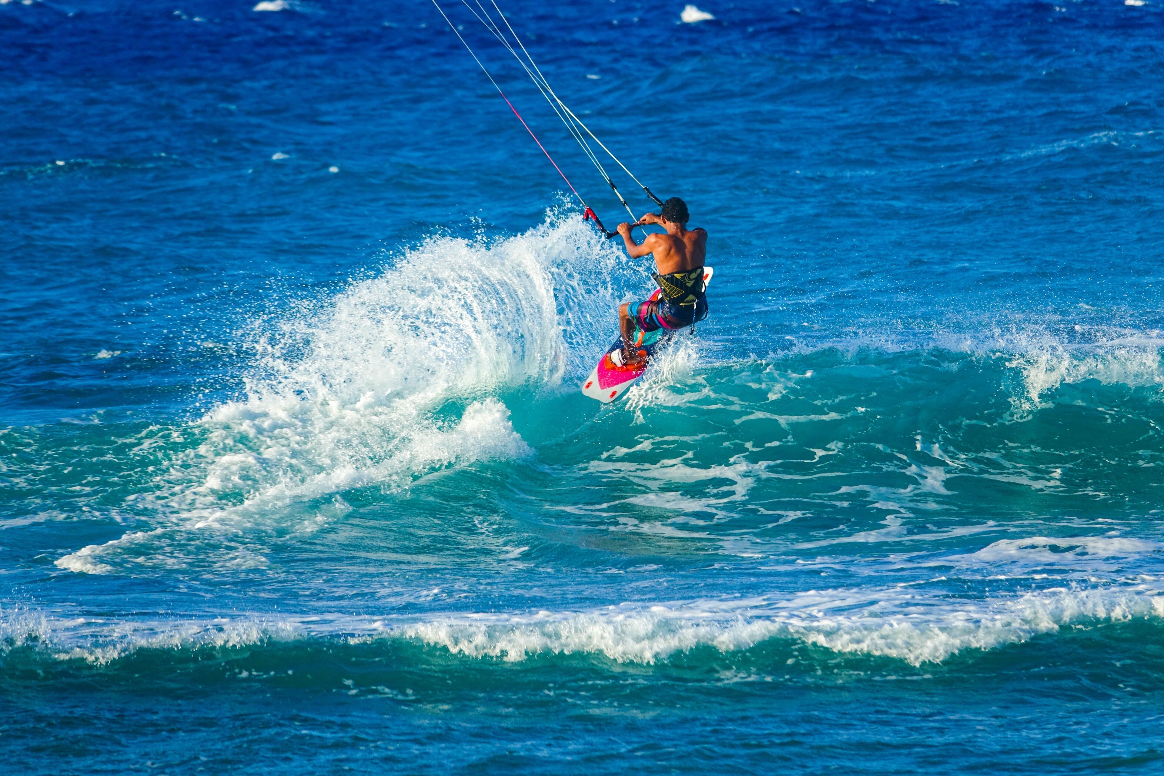 A person windsurfing on a wave.