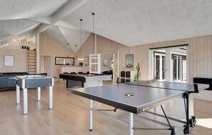 Enjoy games and entertainment in this room with a pool table, foosball table, and ping pong table.