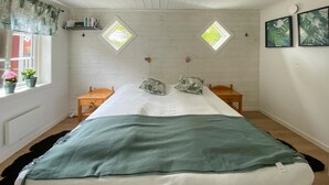A bedroom with a bed, two nightstands, a window, and a skylight. - Awesome home in Löttorp with kitchen (Löttorp)