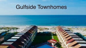 A beachfront townhome complex with a central courtyard and ocean views.
