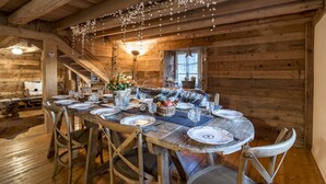 A wooden dining table set with plates, glasses, and a centerpiece. - High standing Vosges farmhouse, Les Bois du Cerf (Gérardmer)