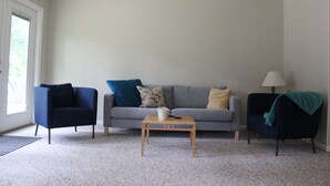A living room with a grey sofa, two armchairs, a wooden coffee table, and a lamp. - Clean and open 3bd/2ba in a quiet close-in neighborhood (Tallahassee)