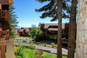 A resort with multiple buildings, a swimming pool, and a road with a guardrail.