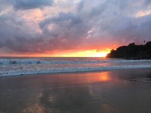 A beach with waves and a sunset. - Beautiful vacation home with ocean views nestled in the jungle with a pool (Chacala)