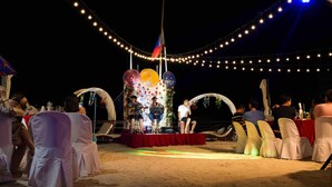 An outdoor event with a stage, chairs, and a flag. - Jelly's Haven Resort (Santa Fe)