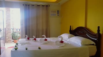 Cortinas blackout, tabla de planchar con plancha y ropa de cama